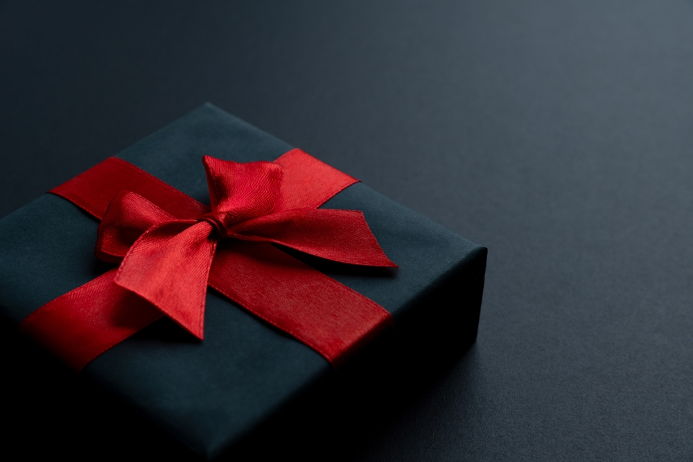 A,black,gift,box,with,a,vibrant,red,satin,ribbon